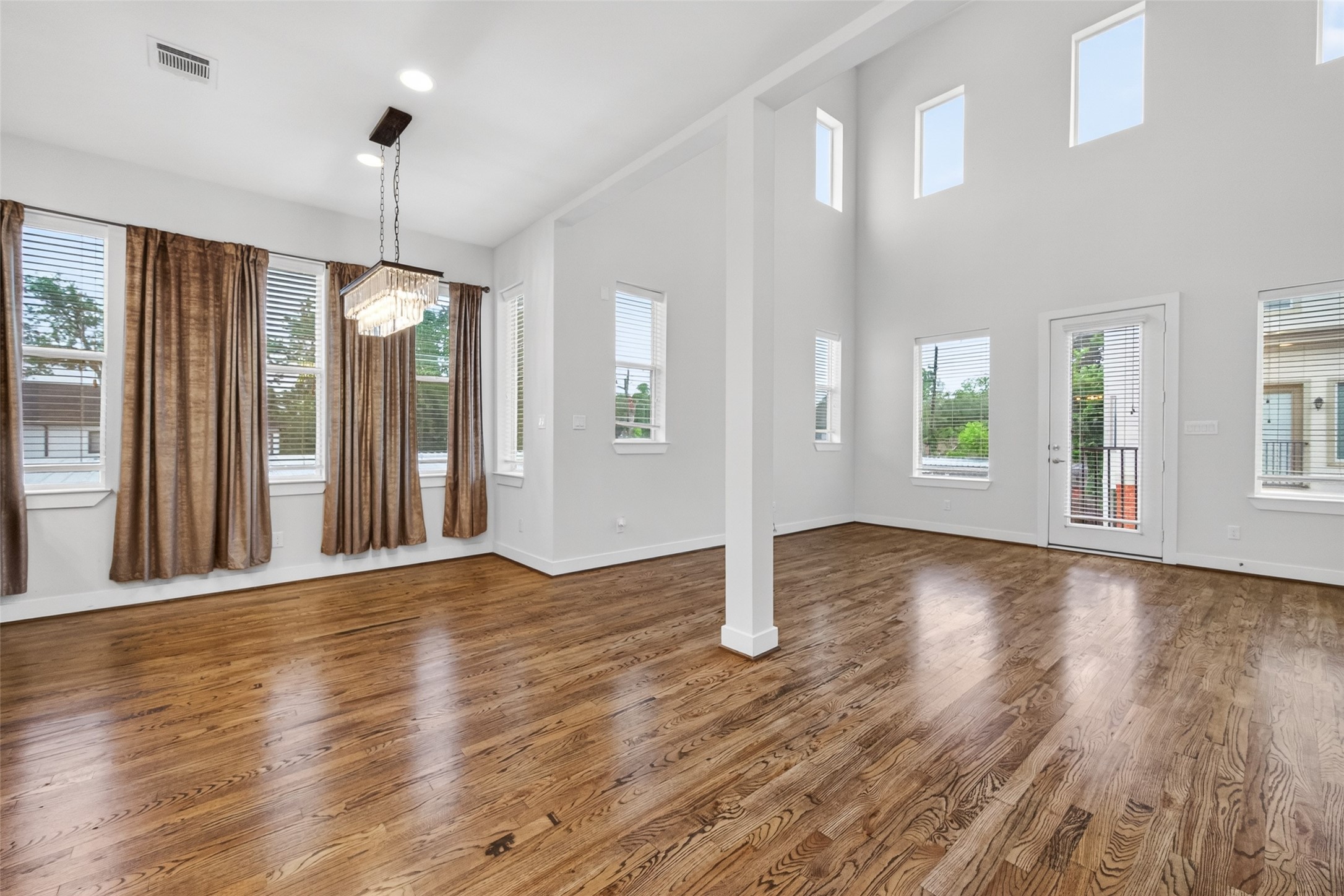 1202 Cedarpost Tree Springs Place Houston, TX 77055 - Photo 9 of 45 a view of an empty room with window and wooden floor