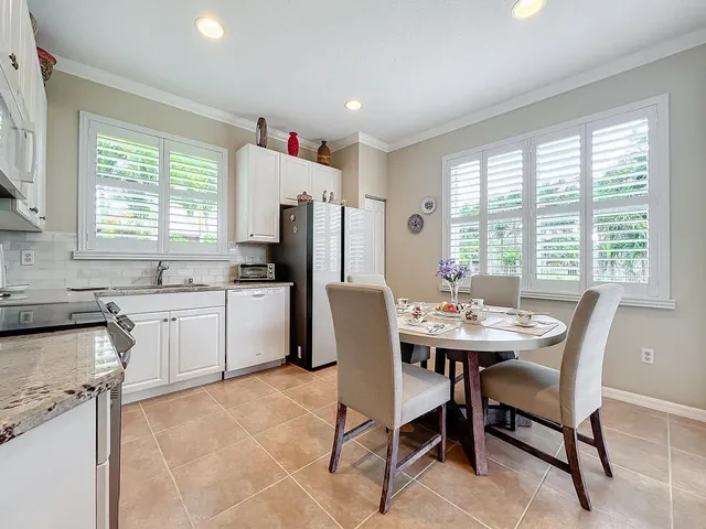 a view of a dining room with furniture and a large window