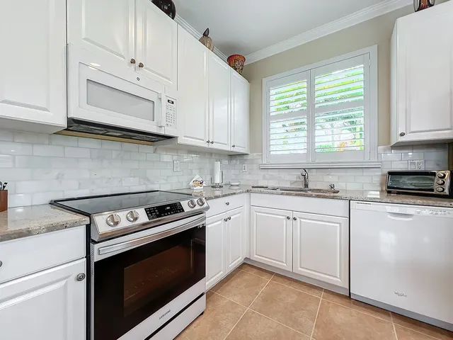 a spacious bathroom with a tub sink and mirror