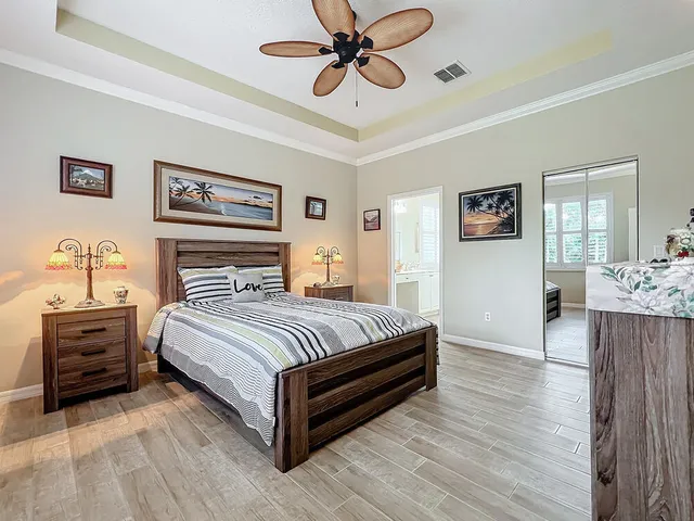 a spacious bathroom with a tub a double vanity sink a window and a mirror