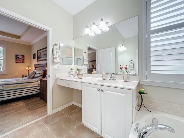 a living room with furniture a window and a flat screen tv