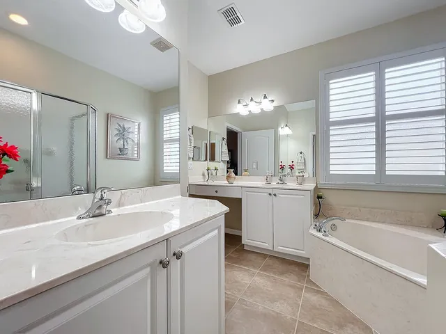 a bedroom with a bed and a couch with wooden floor