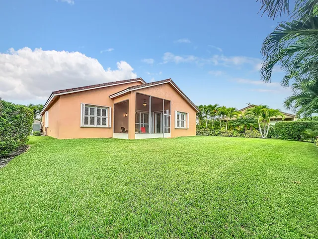 a view of a tall building in the middle of a park