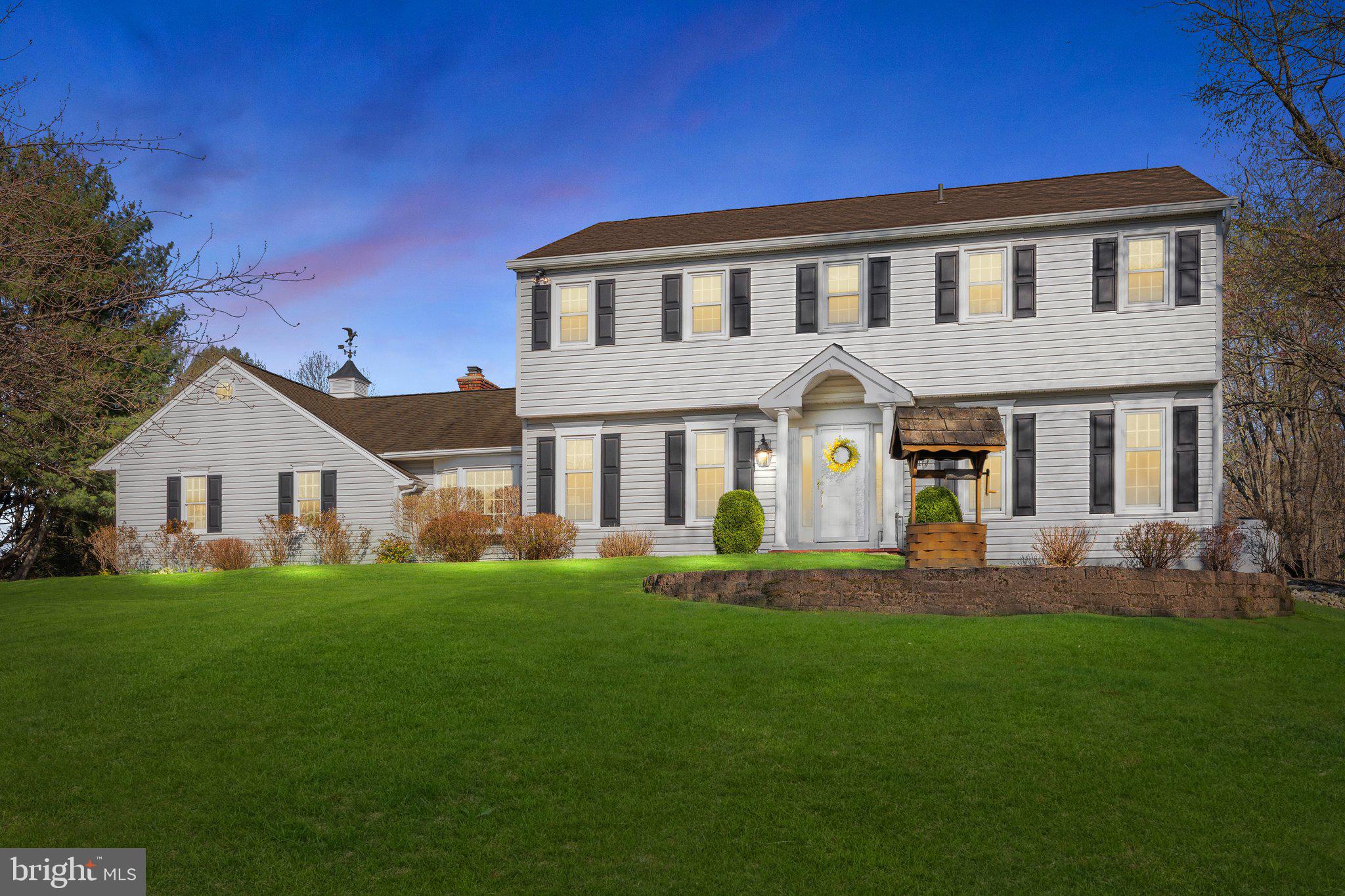 a front view of a house with a garden and yard