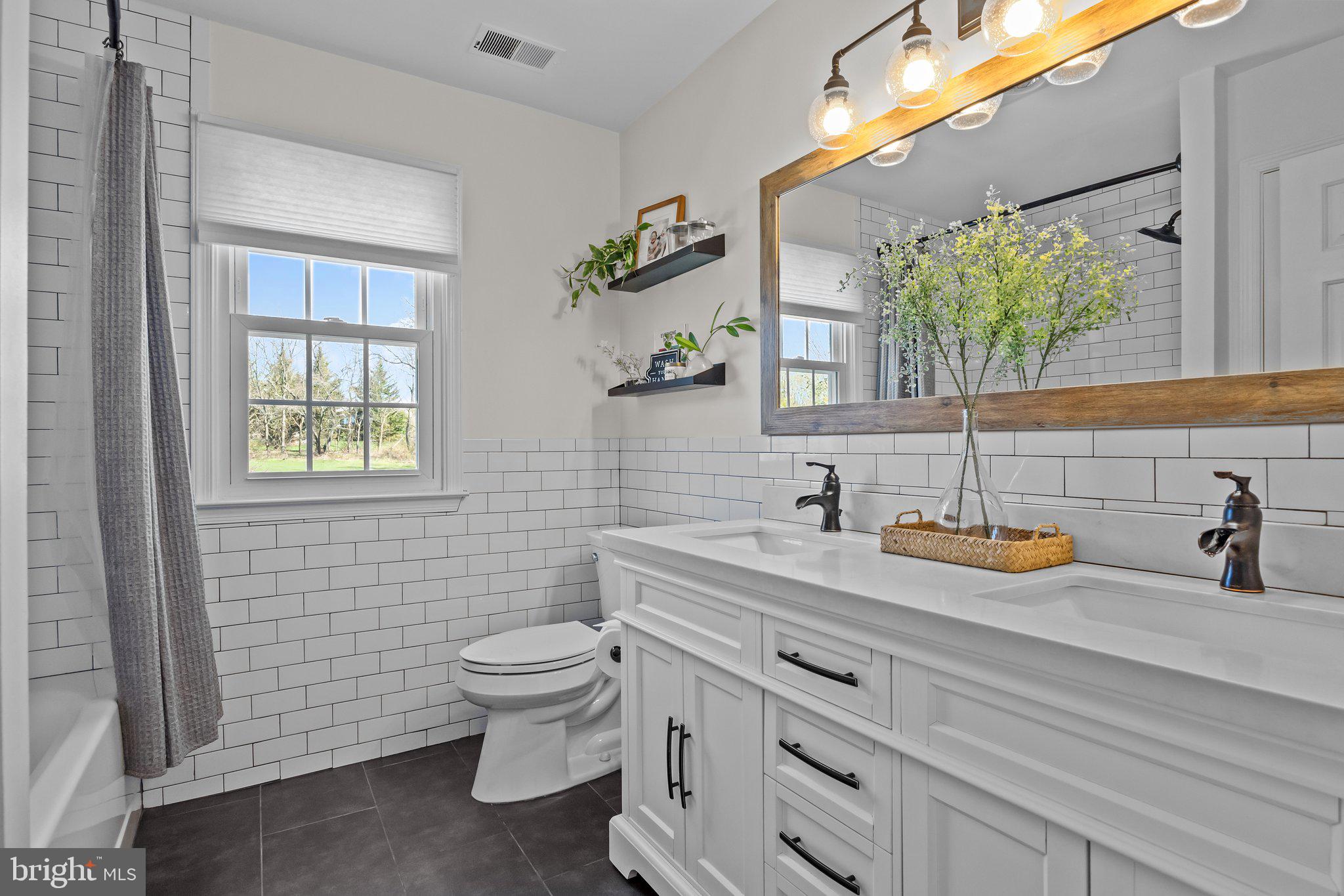 85 Brownsburg Road Newtown, PA 18940 - Photo 40 of 66 a bathroom with a toilet sink and mirror