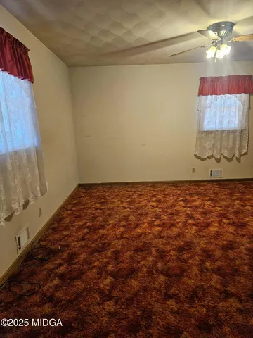 a view of room with a ceiling fan and window