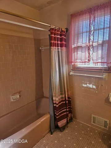 a bathroom with a bathtub and shower