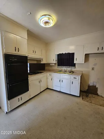a kitchen with stainless steel appliances a stove a sink and a microwave