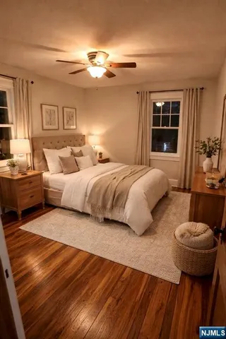 a spacious bedroom with a bed and wooden floor