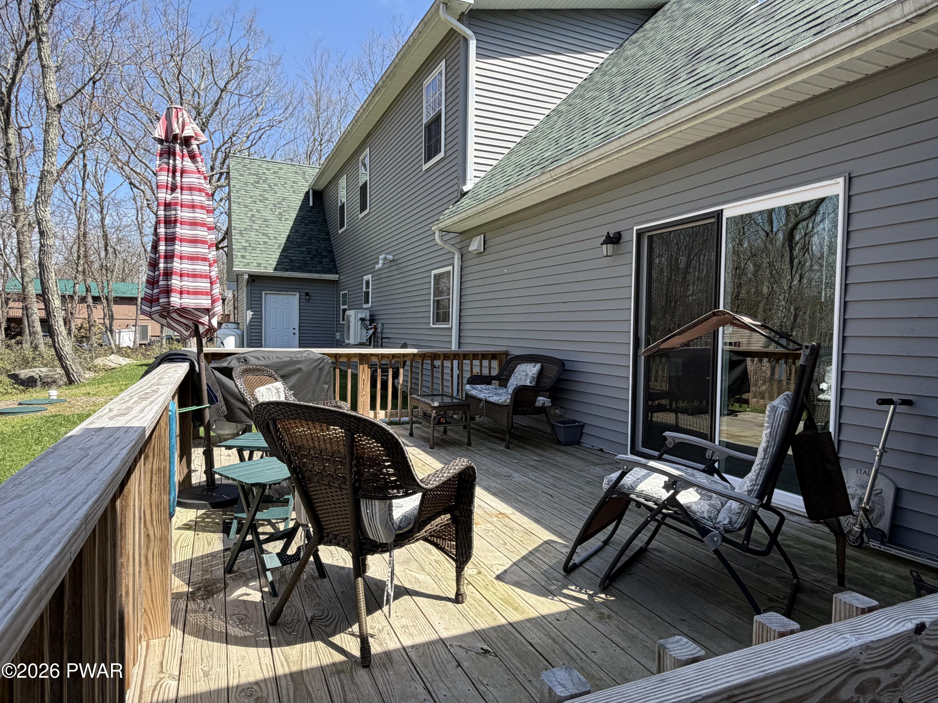 801 Maple Ridge Court Hawley, PA 18428 - Photo 6 of 55 a view of a roof deck with table and chairs with wooden floor and fence