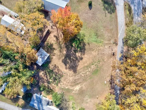 a backyard of a house with a tree