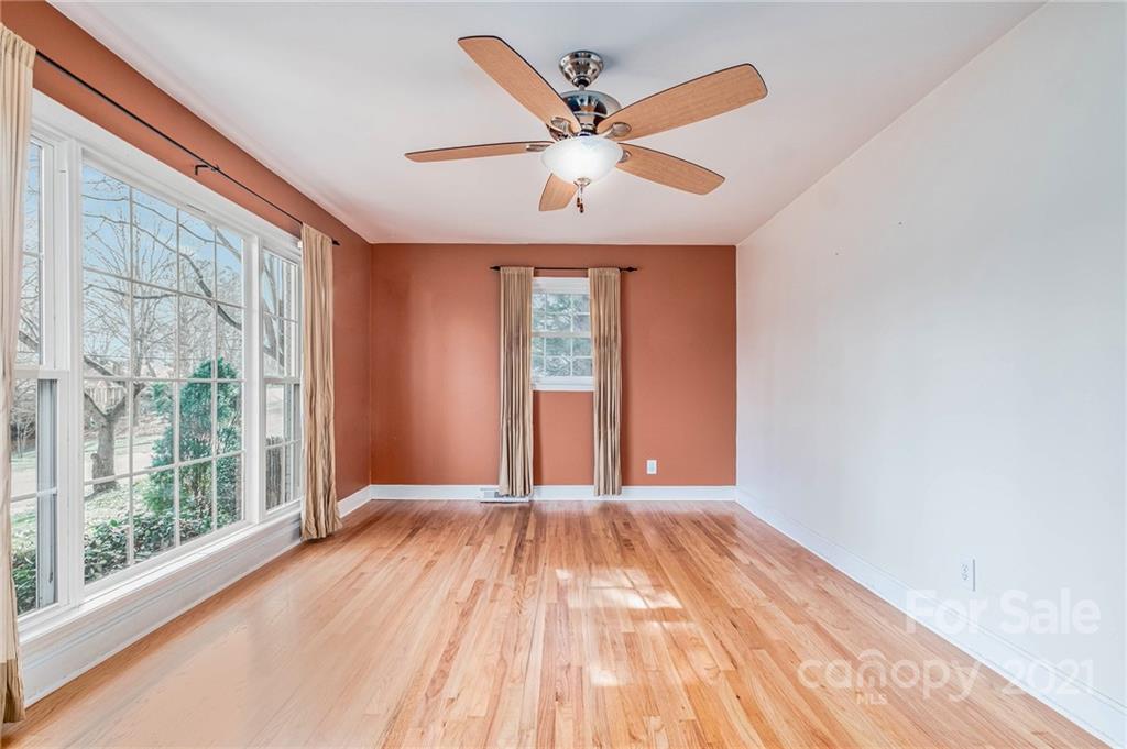 7330 Watercrest Road Charlotte, NC 28210 - Photo 8 of 21 a view of an empty room with wooden floor and a window