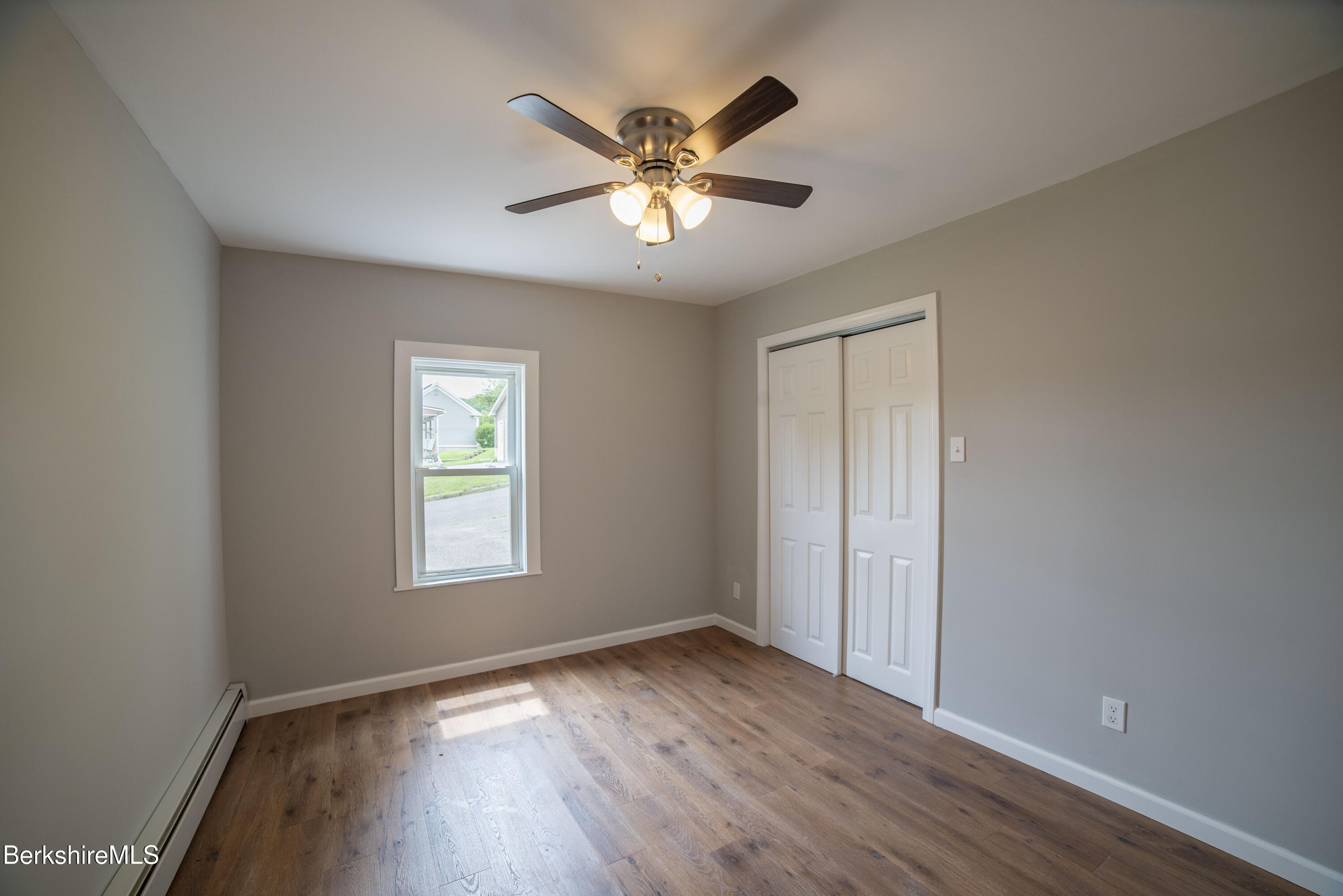 7 Hughes Street Adams, MA 01220 - Photo 11 of 22 an empty room with wooden floor and windows