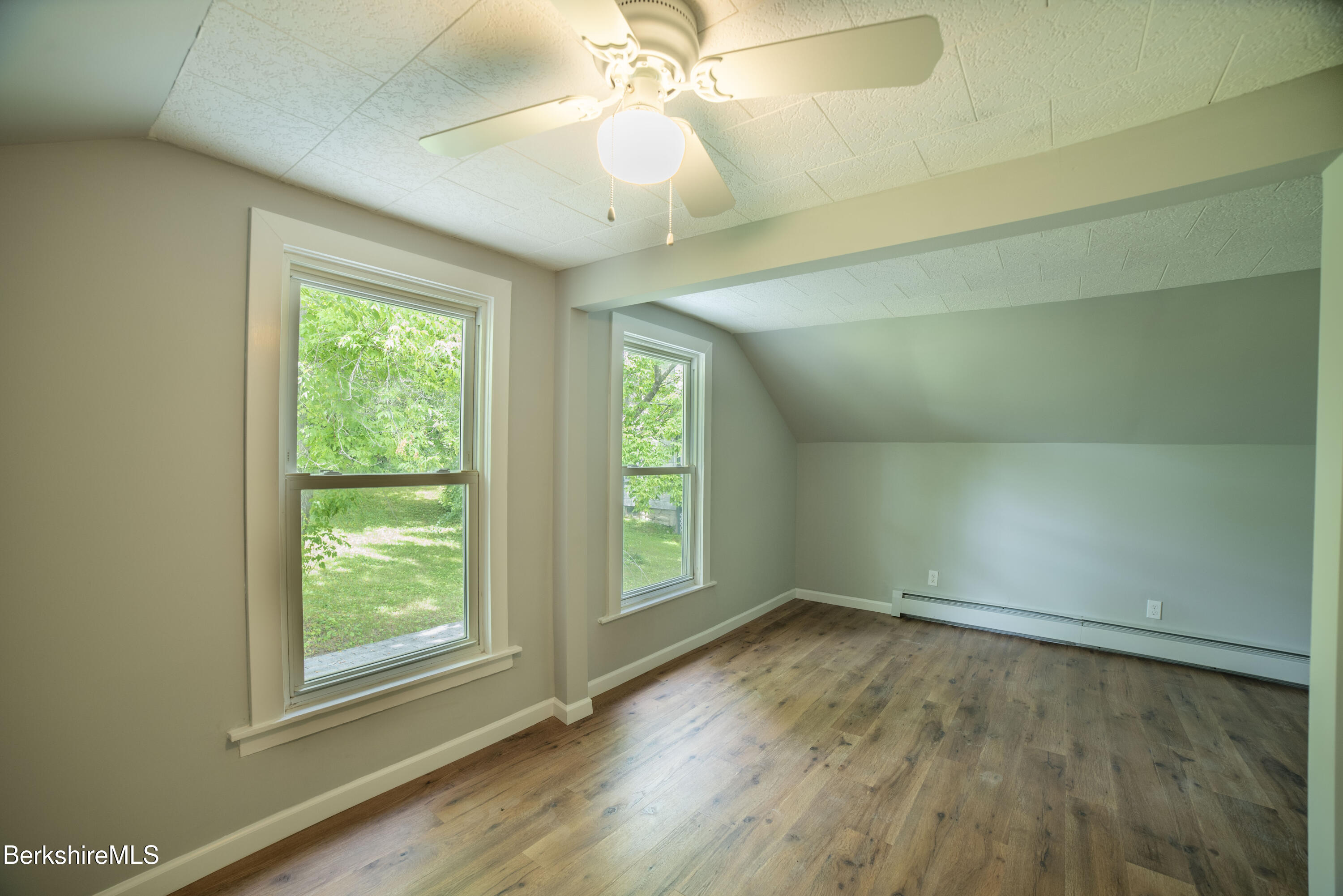 7 Hughes Street Adams, MA 01220 - Photo 13 of 22 an empty room with wooden floor and windows