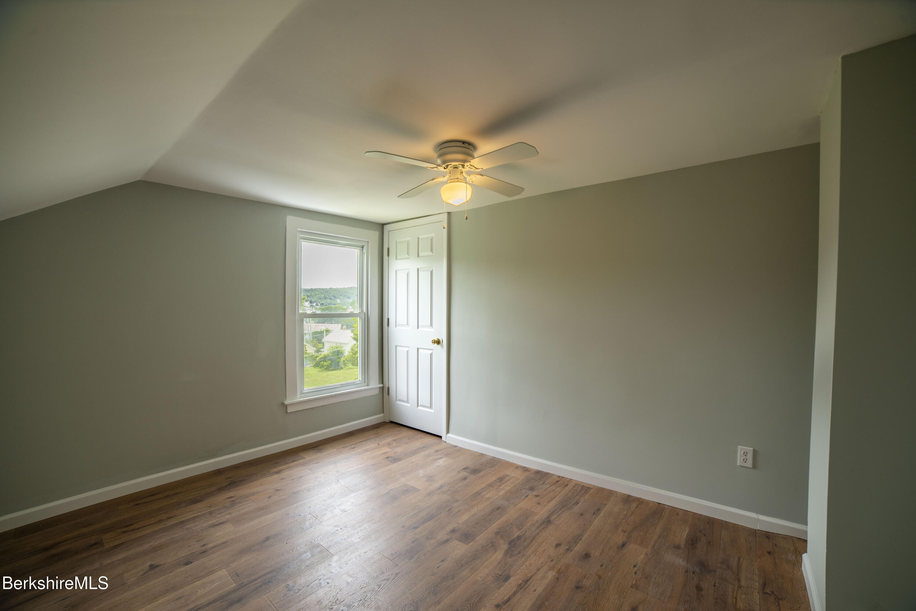 7 Hughes Street Adams, MA 01220 - Photo 14 of 22 an empty room with wooden floor and windows