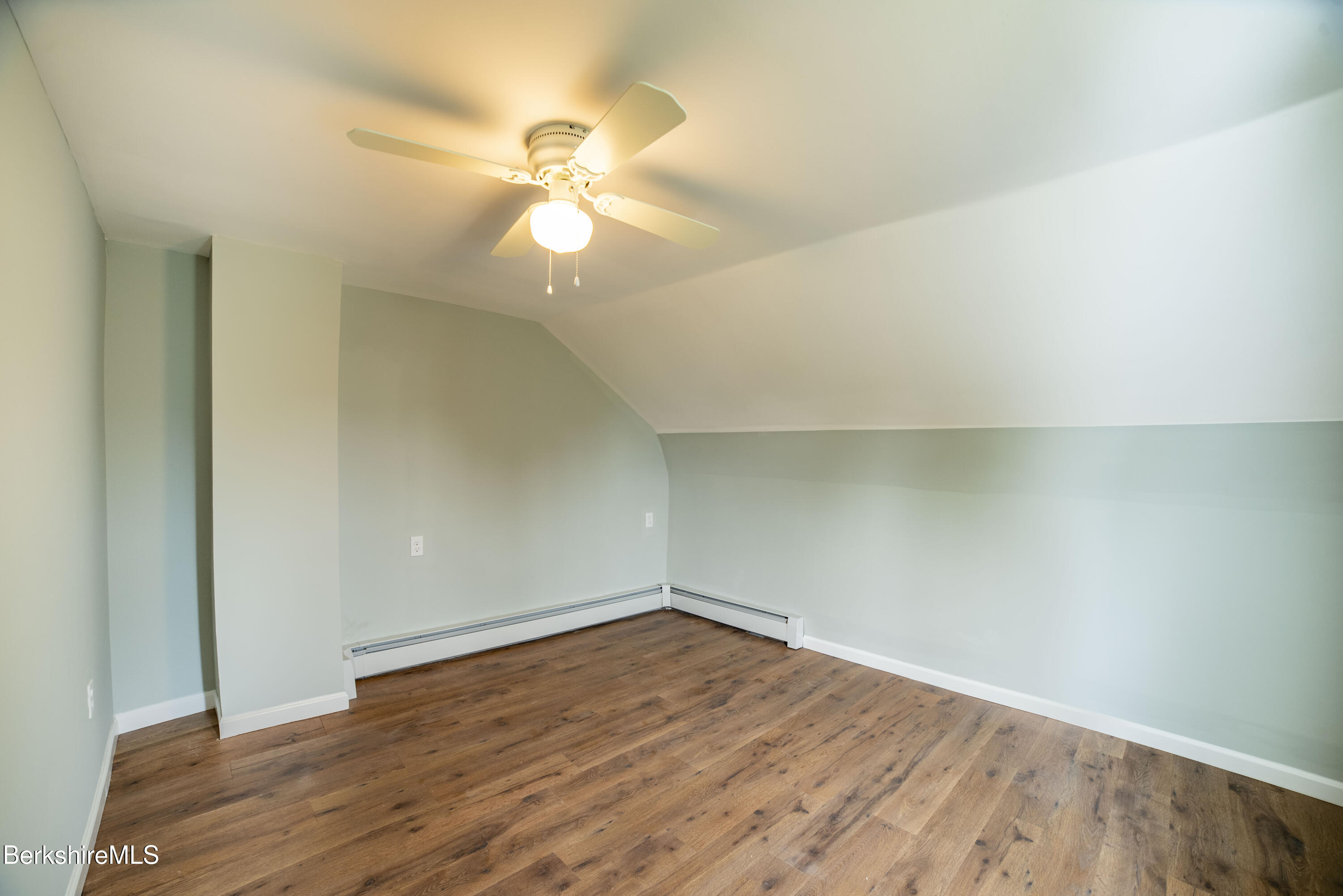 7 Hughes Street Adams, MA 01220 - Photo 15 of 22 an empty room with wooden floor and fan