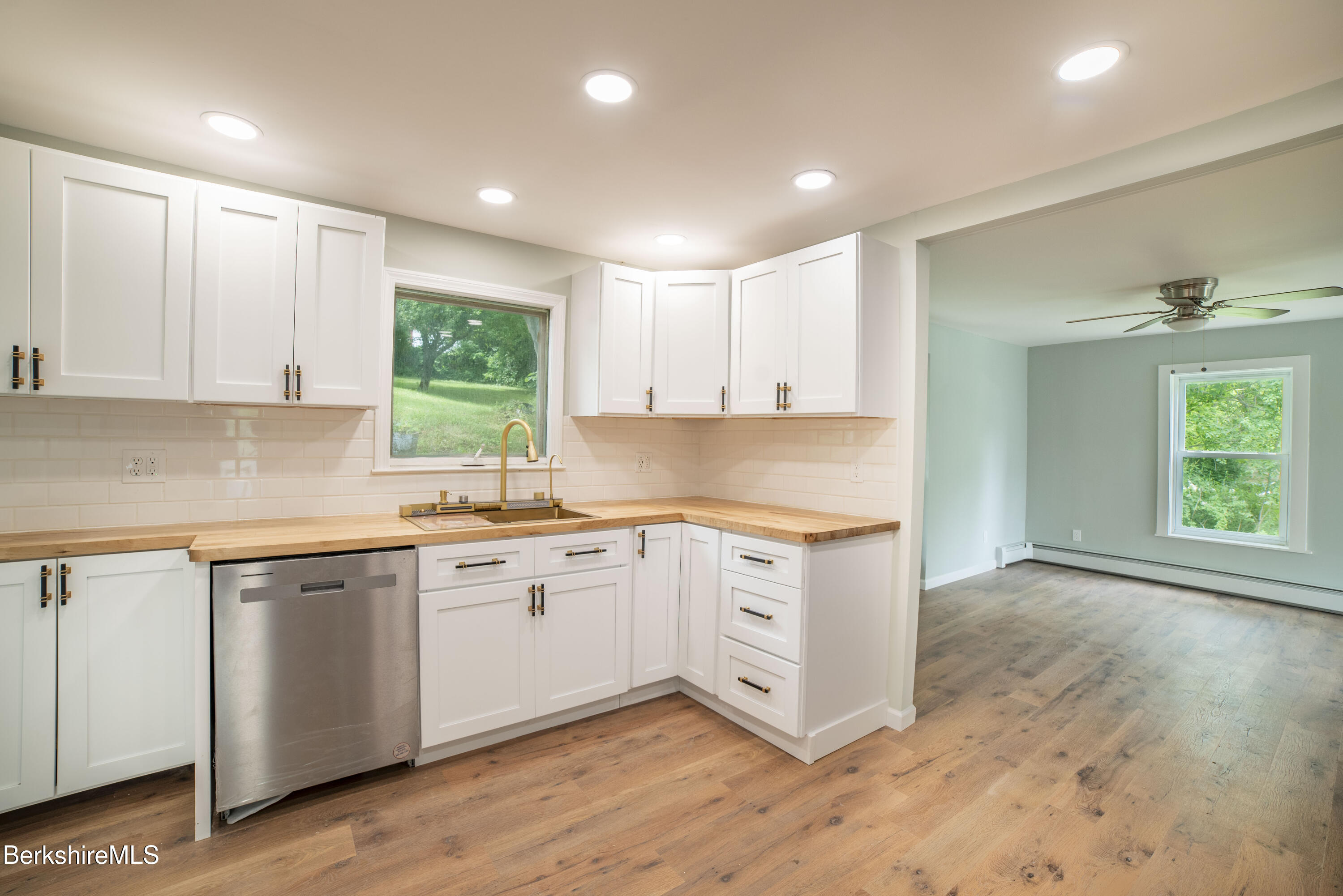7 Hughes Street Adams, MA 01220 - Photo 5 of 22 a kitchen with stainless steel appliances granite countertop a stove a sink and a microwave