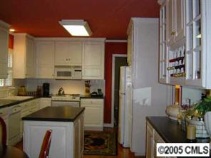 3031 Wickersham Road Charlotte, NC 28211 - Photo 3 of 8 a kitchen with a sink a refrigerator and cabinets