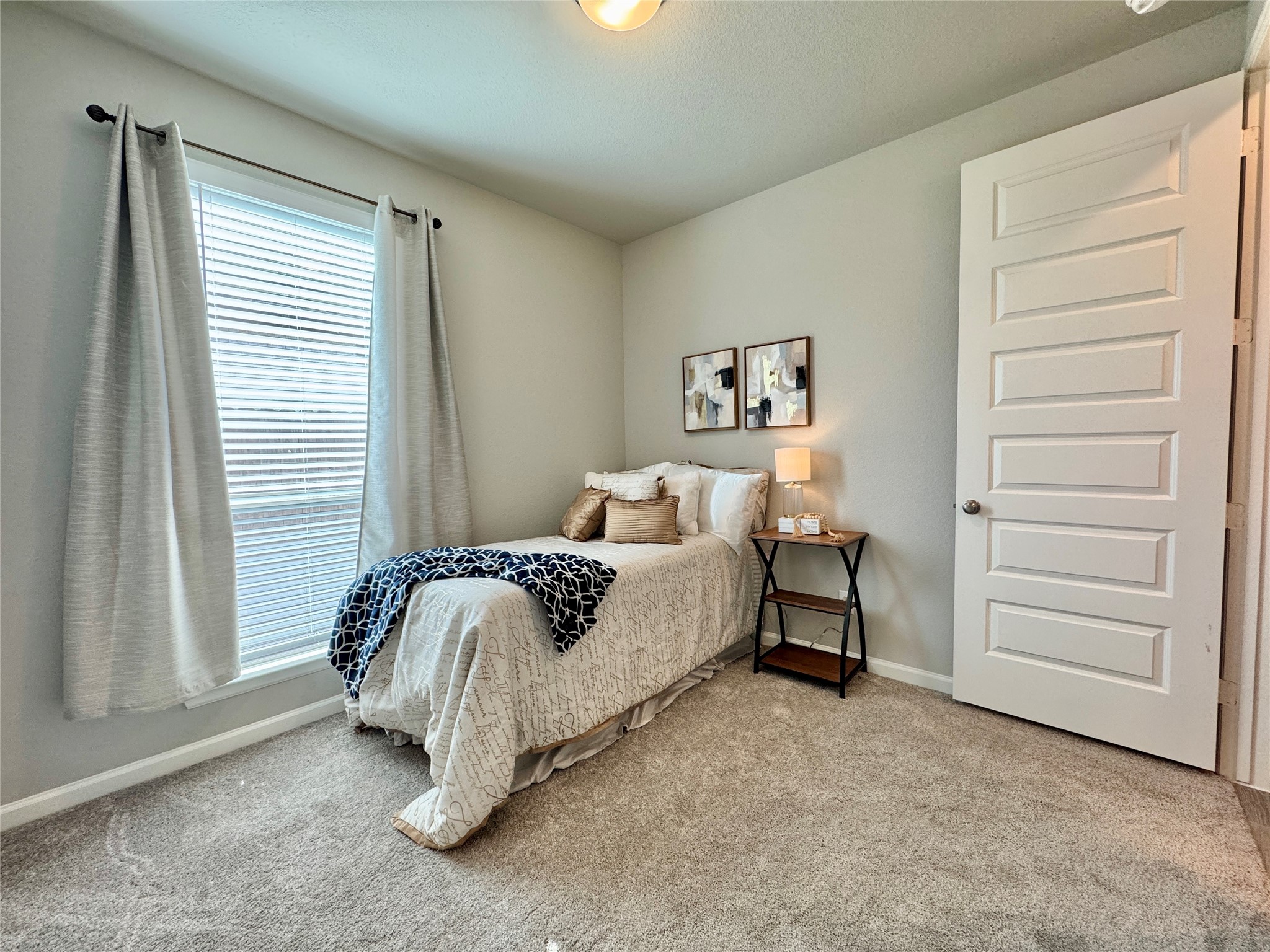 11231 Burgus Farm Road Humble, TX 77346 - Photo 18 of 30 Spacious secondary bedroom featuring high-quality neutral finishes, ample closet storage, and a large window. Its location adjacent to a full bath ensures comfort and accessibility for family or guests alike.