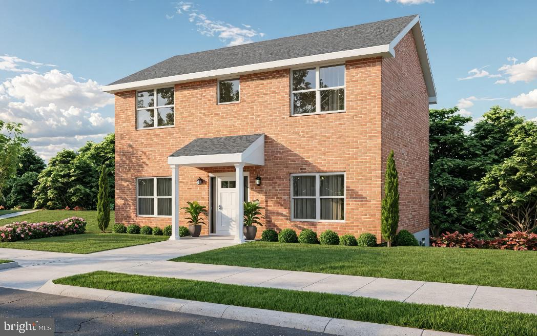 a front view of a house with a yard and road