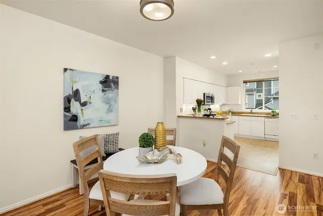 a view of a dining room with furniture and wooden floor