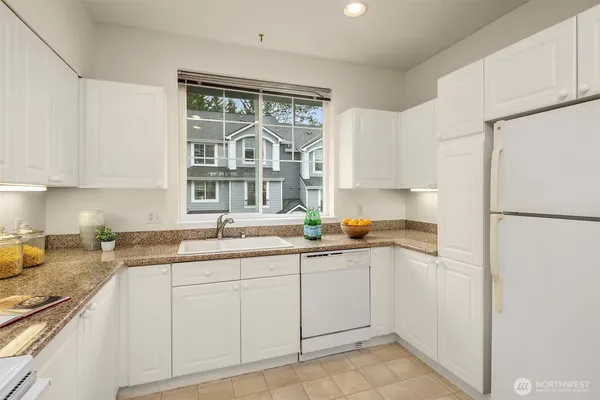 a kitchen with a sink cabinets and window