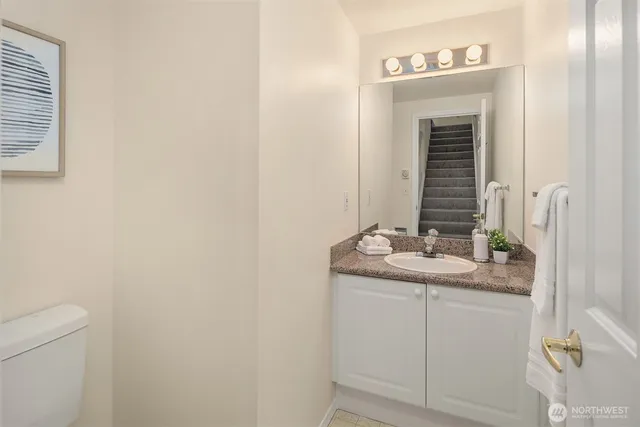 a bathroom with a granite countertop sink and a mirror