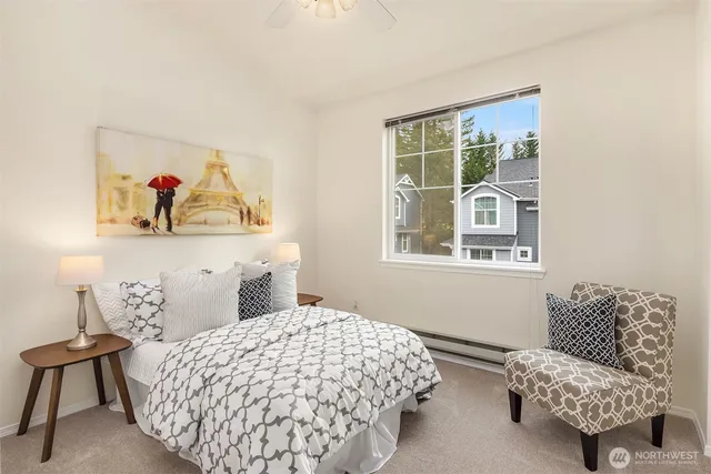 a bedroom with a bed and a painting on the wall