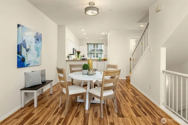 a dining room with wooden floor and breakfast area
