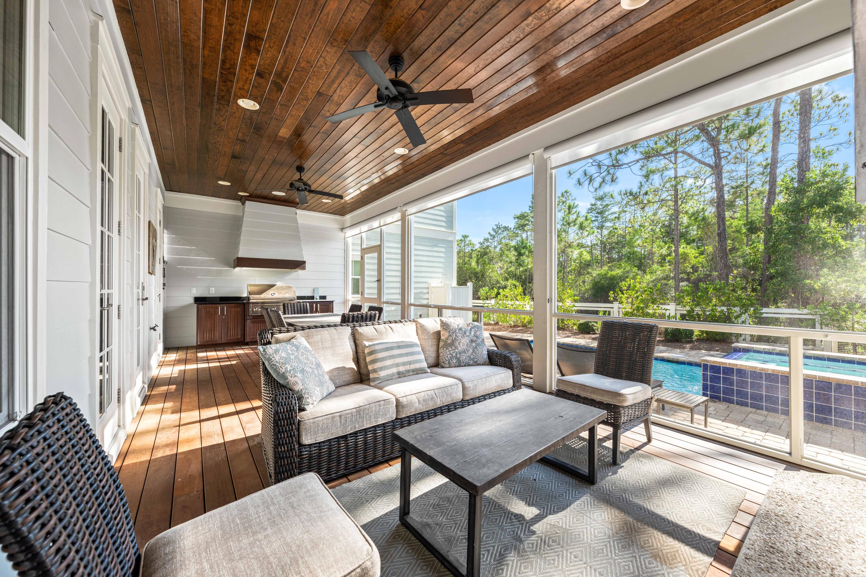 655 East Royal Fern Way Santa Rosa Beach, FL 32459 - Photo 30 of 75 a living room with furniture a fireplace and a table
