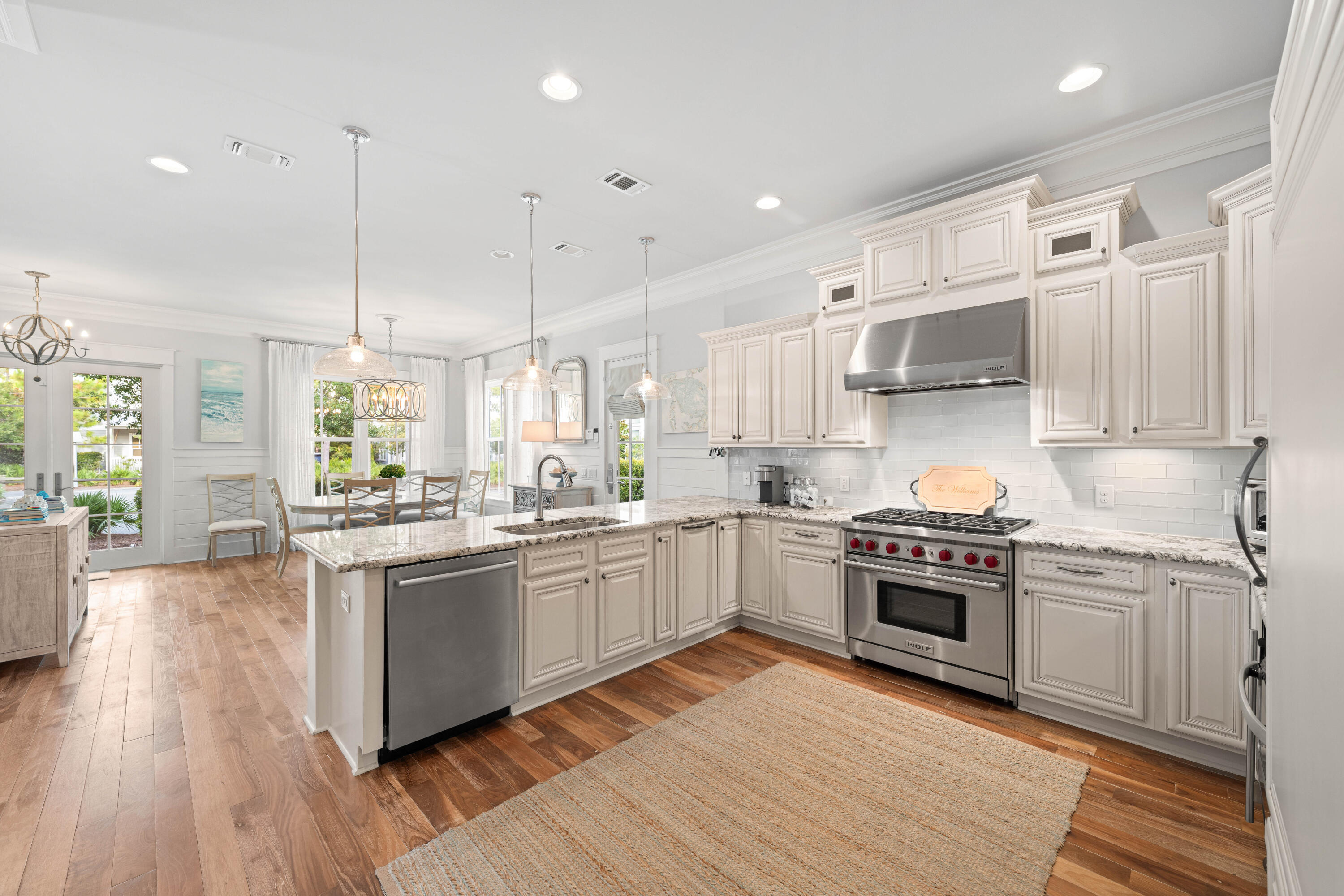 655 East Royal Fern Way Santa Rosa Beach, FL 32459 - Photo 8 of 75 a kitchen with stainless steel appliances granite countertop wooden floor sink stove and wooden floor