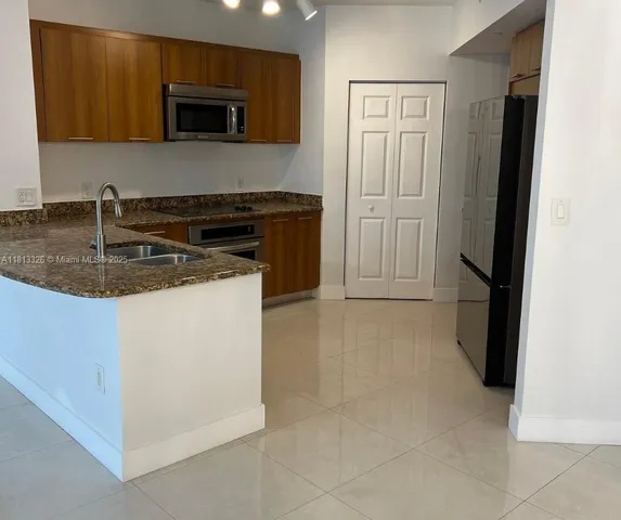 a kitchen with a sink stove and refrigerator