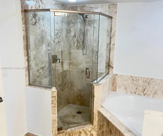 a bathroom with a shower and a bathtub