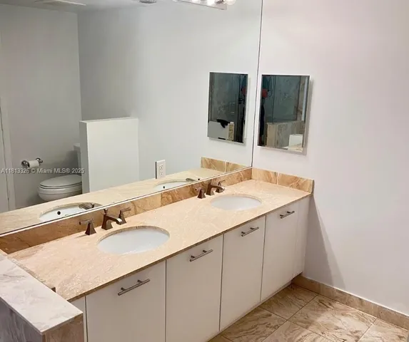 a bathroom with a sink and mirror