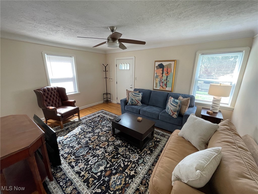 1539 Winchester Road Lyndhurst, OH 44124 - Photo 8 of 21 Living room with light hardwood / wood-style floors, a textured ceiling, and ceiling fan