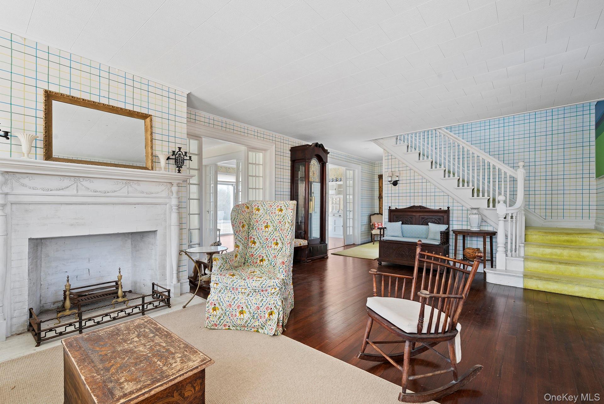 11 Shinnecock Road Quogue, NY 11959 - Photo 19 of 50 a living room with furniture and a fireplace