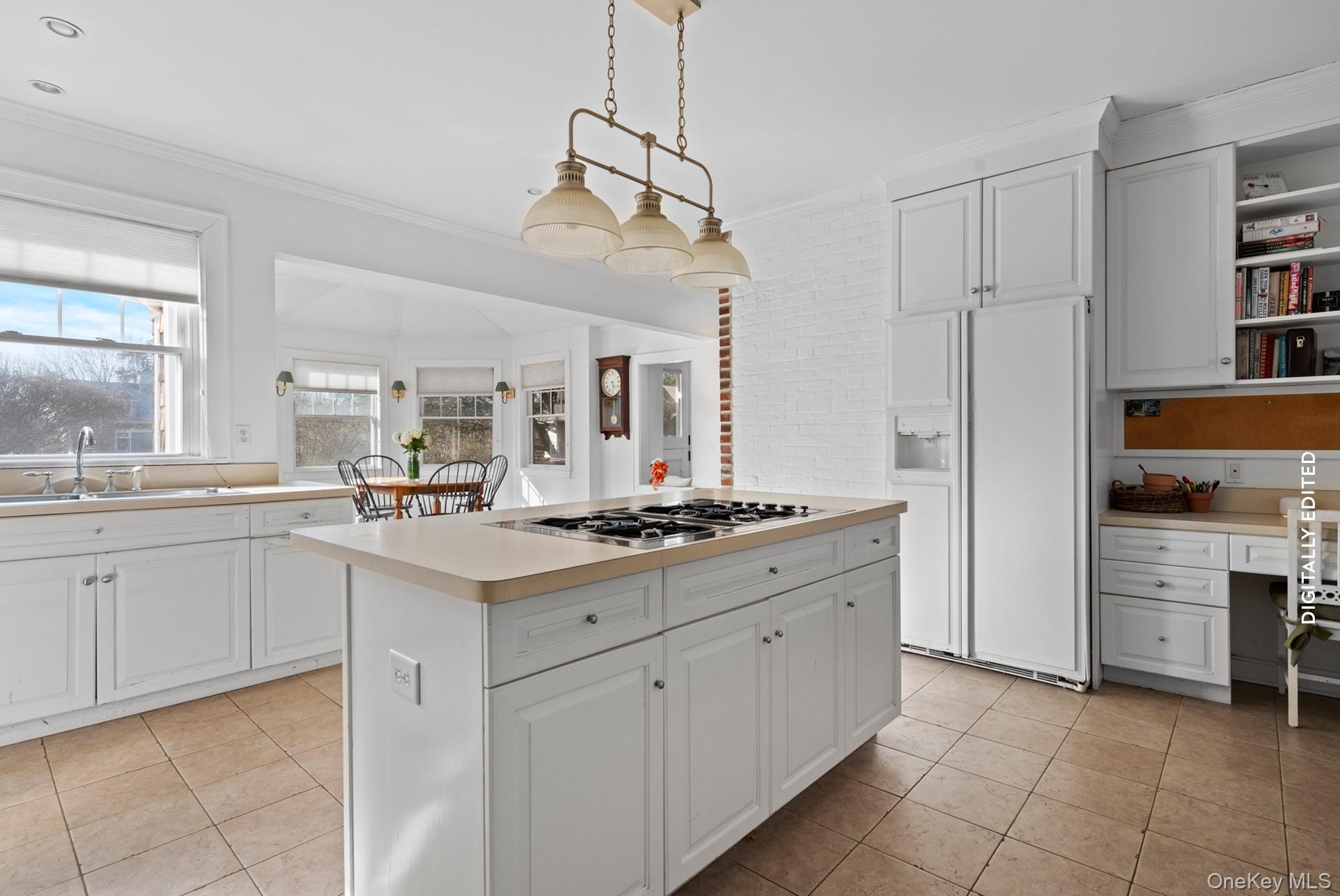 11 Shinnecock Road Quogue, NY 11959 - Photo 22 of 50 a large white kitchen with a stove and a sink