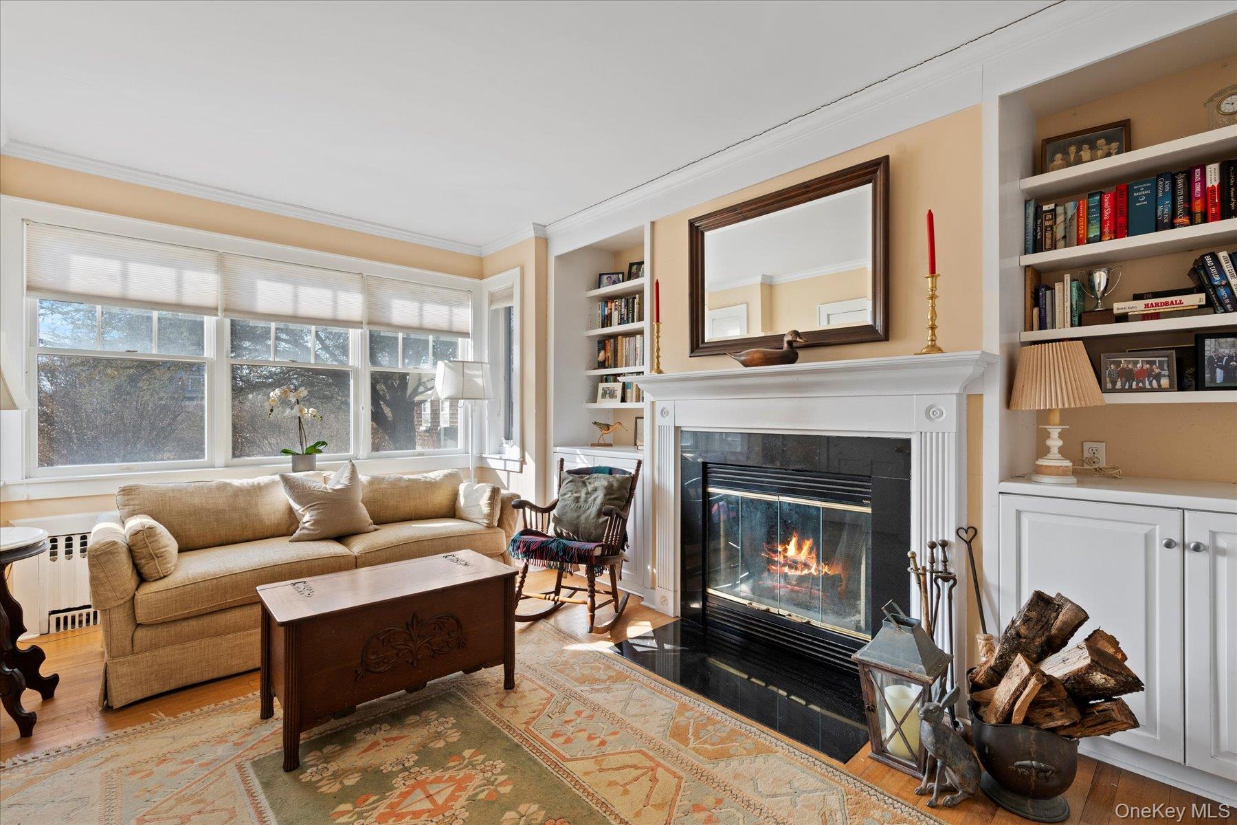 11 Shinnecock Road Quogue, NY 11959 - Photo 28 of 50 a living room with furniture a bookshelf and a fireplace