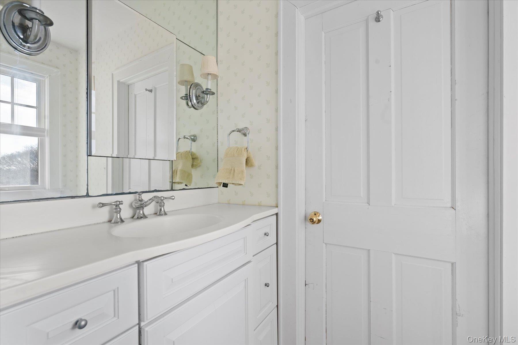 11 Shinnecock Road Quogue, NY 11959 - Photo 31 of 50 a bathroom with a sink and a mirror