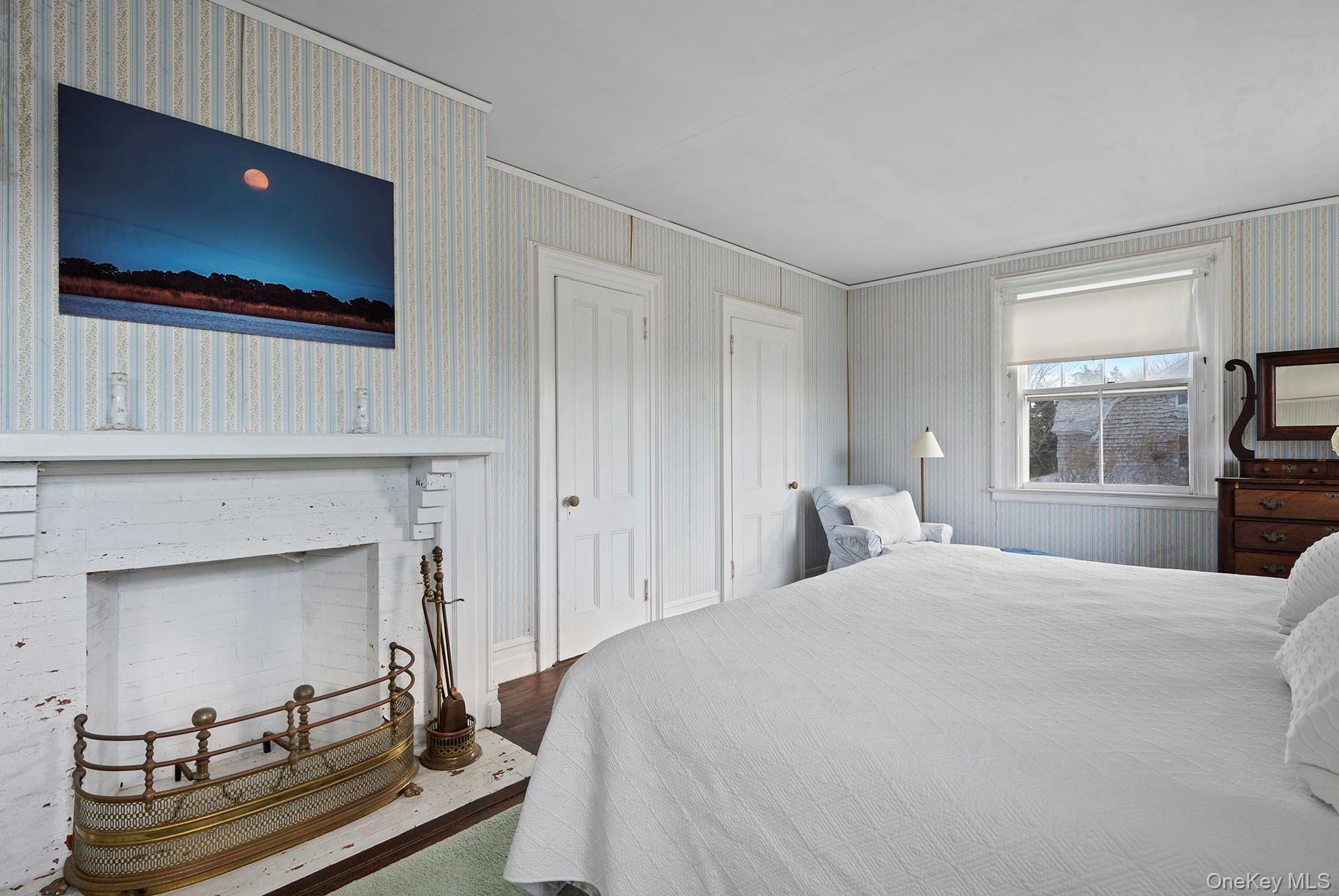 11 Shinnecock Road Quogue, NY 11959 - Photo 34 of 50 a bedroom with a bed and a flat screen tv