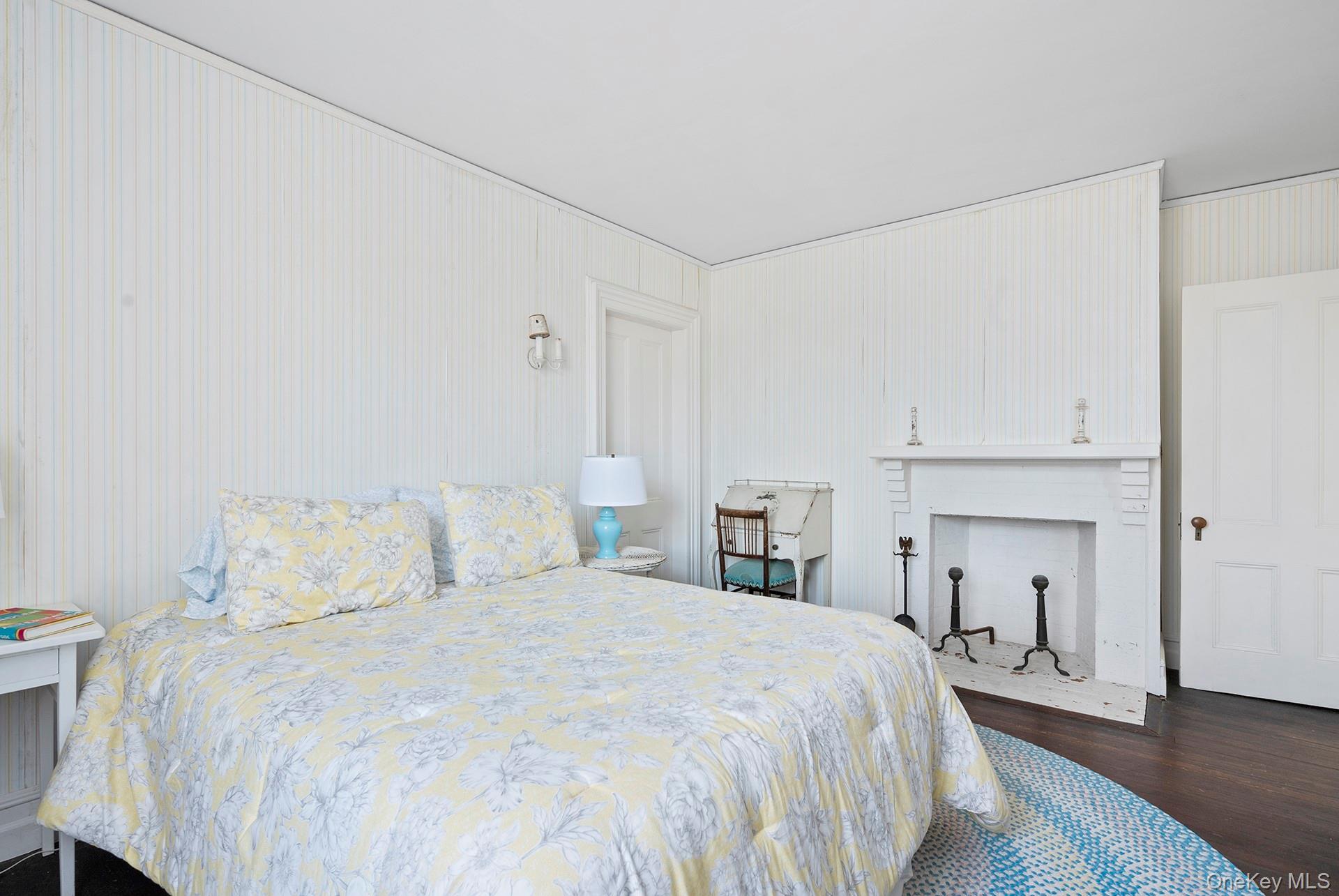 11 Shinnecock Road Quogue, NY 11959 - Photo 36 of 50 a bedroom with a bed and a chandelier