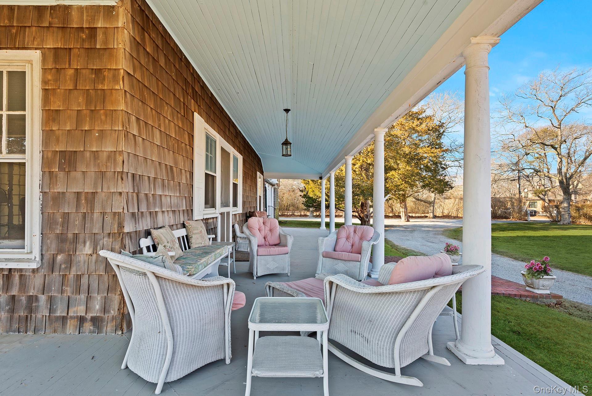 11 Shinnecock Road Quogue, NY 11959 - Photo 42 of 50 a dining room with patio furniture and garden