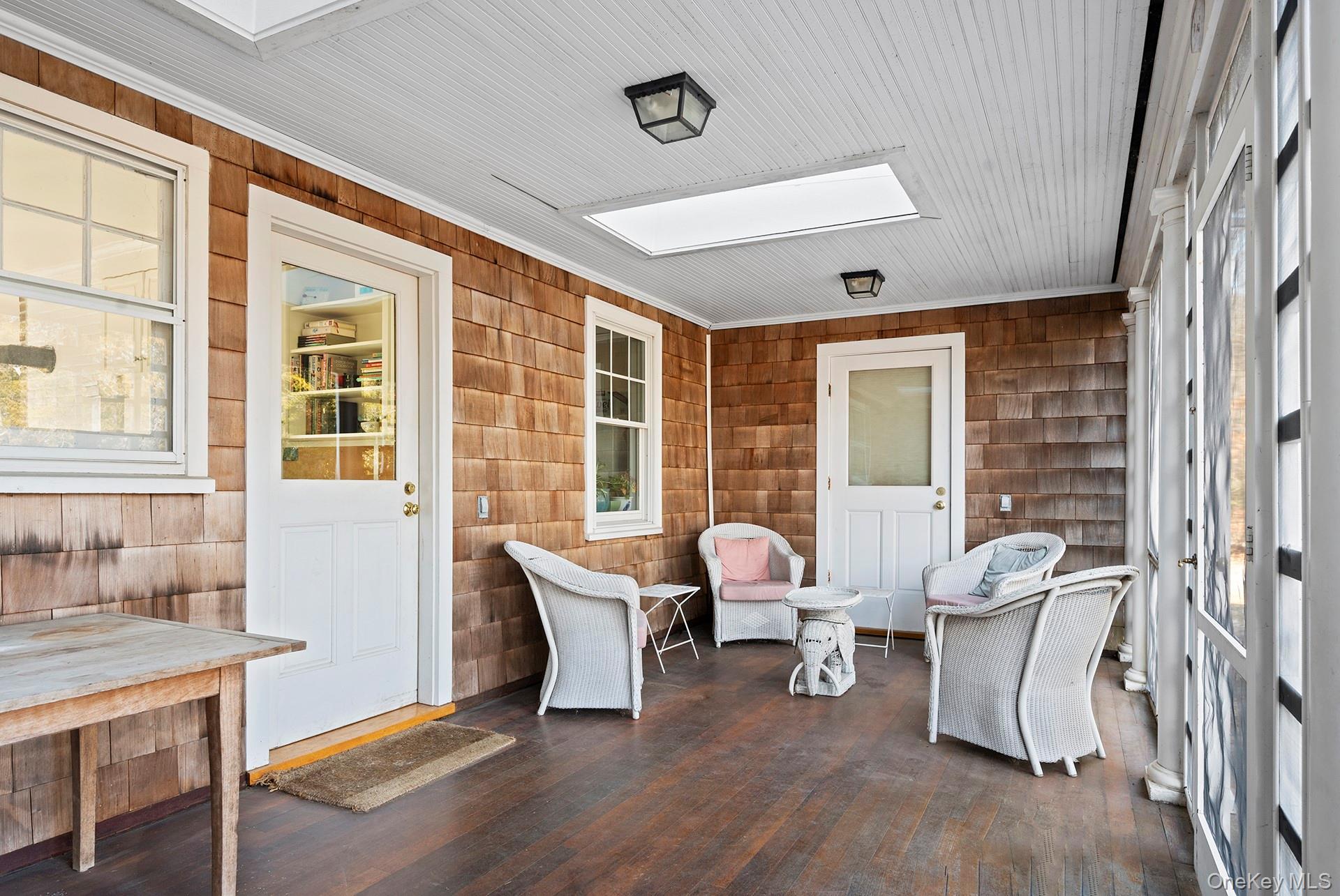11 Shinnecock Road Quogue, NY 11959 - Photo 43 of 50 a living room with furniture and two large window