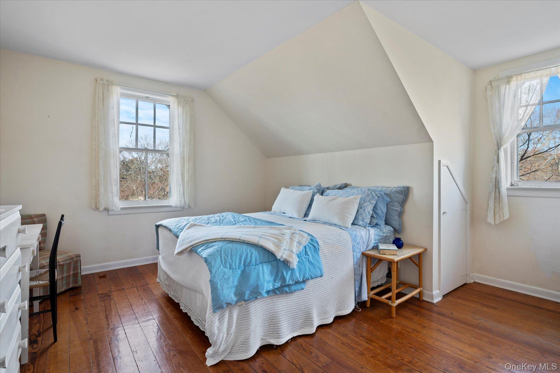 11 Shinnecock Road Quogue, NY 11959 - Photo 47 of 50 a bed sitting in a bedroom next to a window