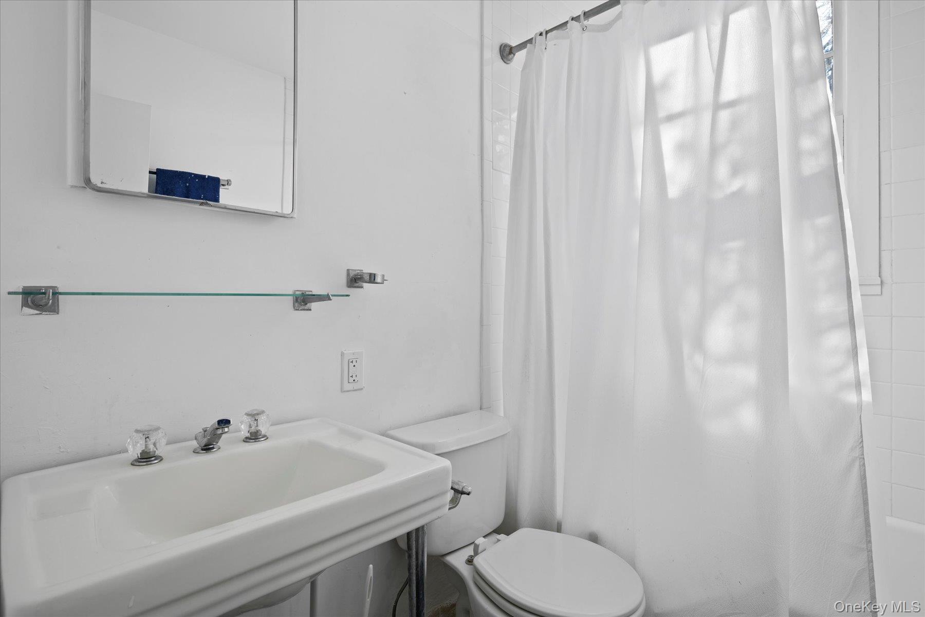 11 Shinnecock Road Quogue, NY 11959 - Photo 48 of 50 a bathroom with a sink a toilet and a mirror
