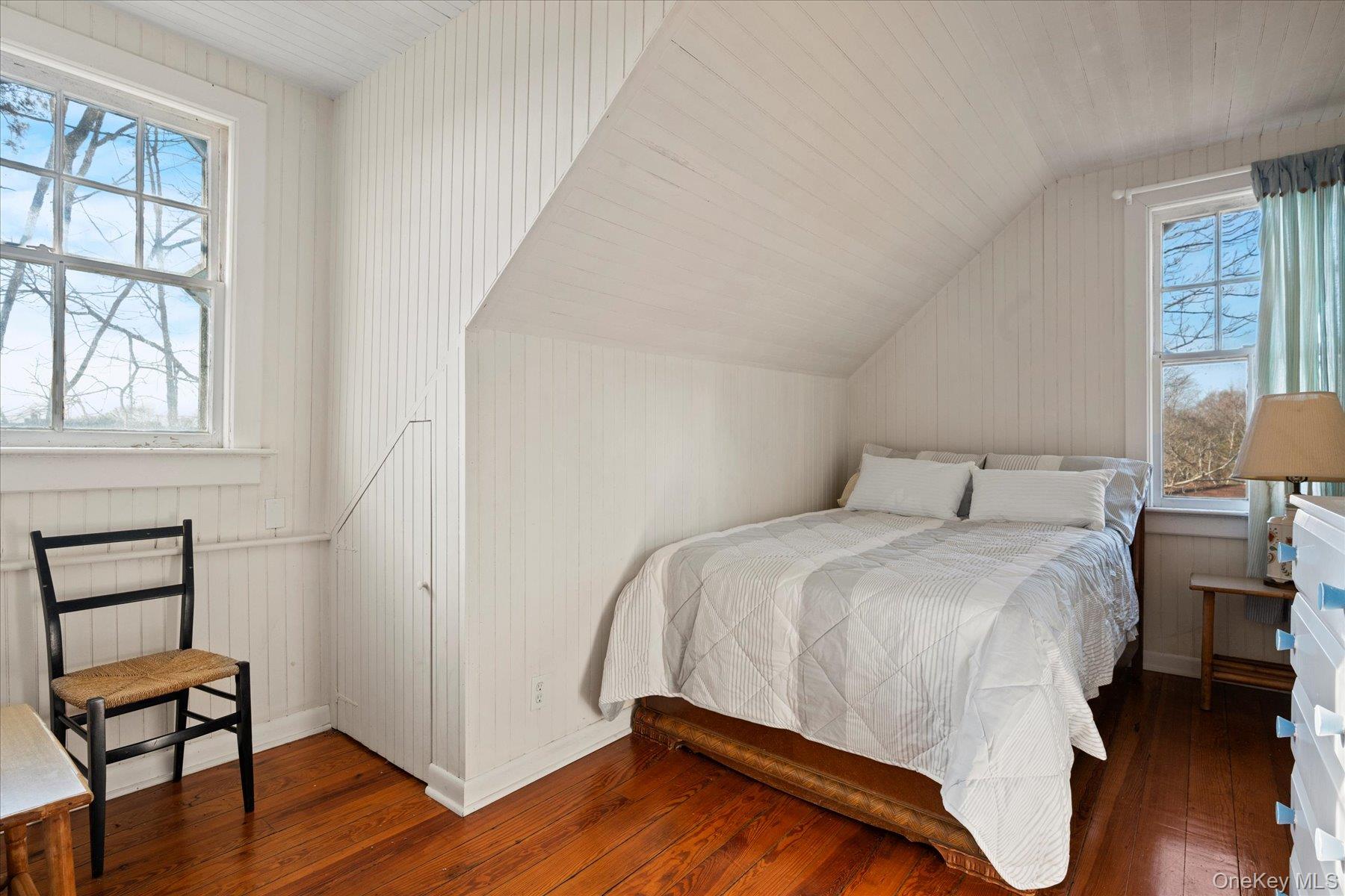 11 Shinnecock Road Quogue, NY 11959 - Photo 49 of 50 a bedroom with a bed and a chair next to a window