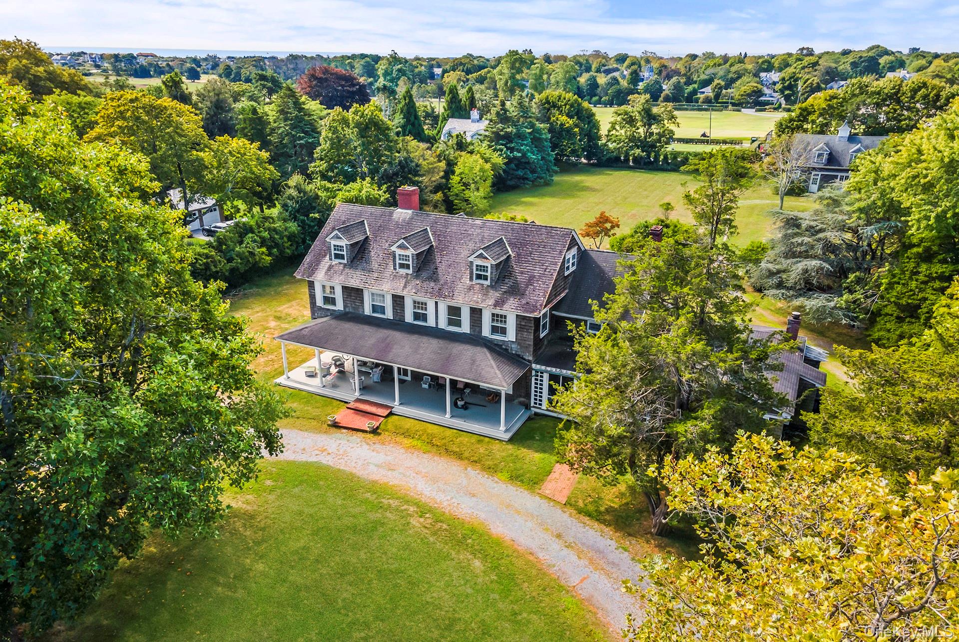 11 Shinnecock Road Quogue, NY 11959 - Photo 50 of 50 an aerial view of a house with a garden and lake view