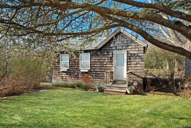 a living room with furniture a fireplace and a chandelier