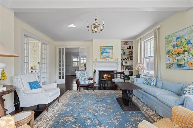 a living room with furniture a flat screen tv and a large window