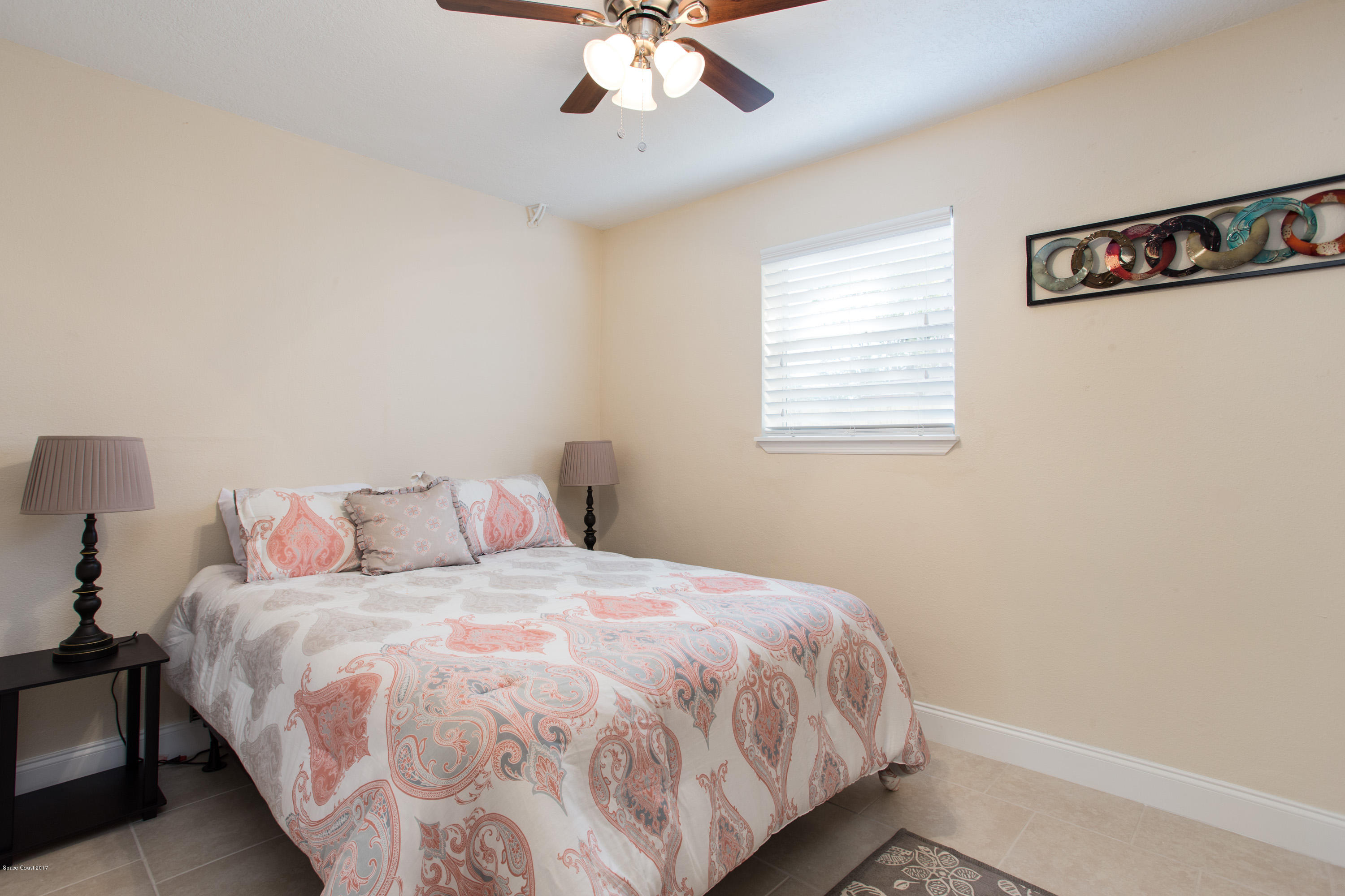 318 West Rutgers Street Melbourne, FL 32901 - Photo 11 of 14 a bedroom with a bed and a ceiling fan